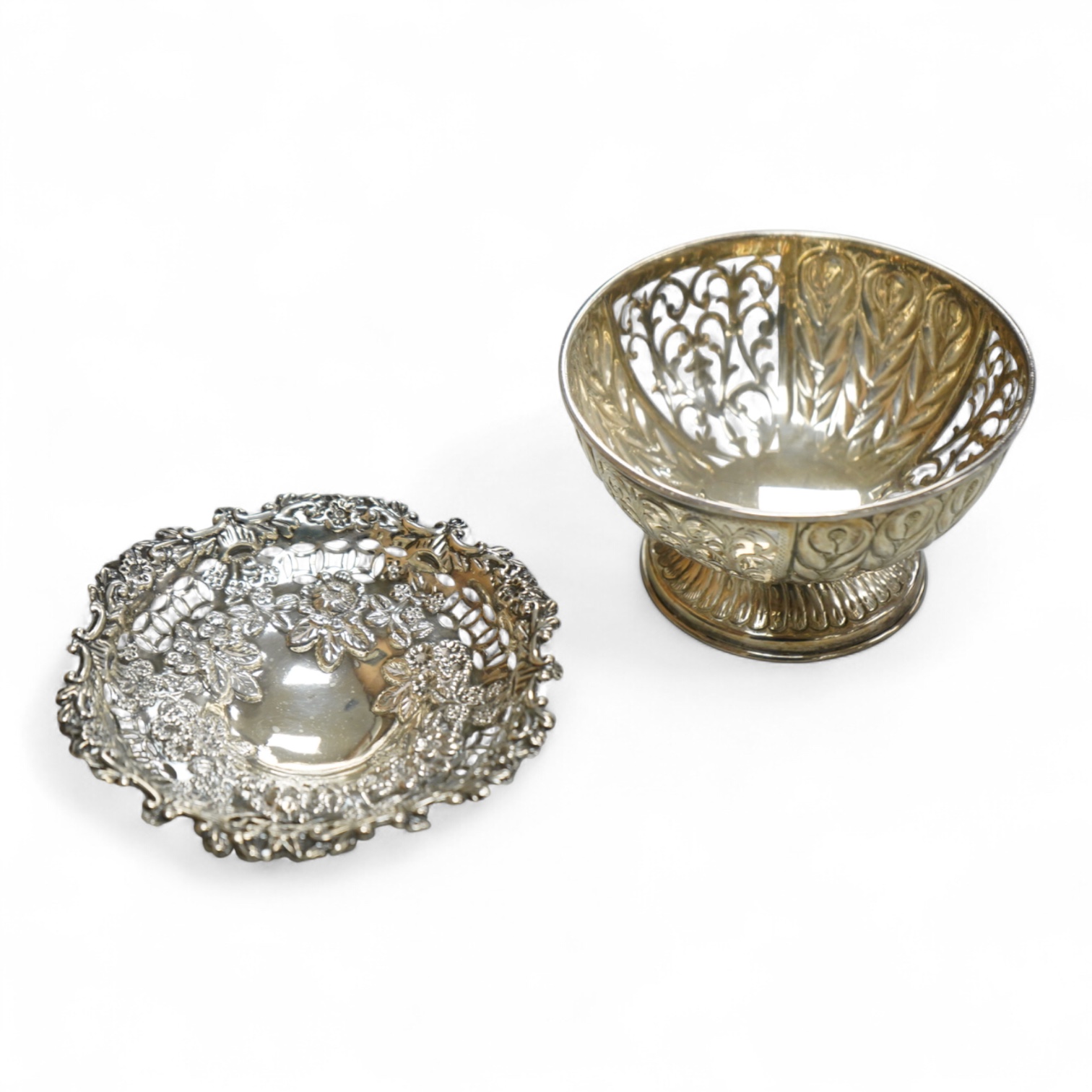 A late Victorian pierced repousse silver bonbon dish, on pierced foot, Nathan & Hayes, Birmingham, 1893, diameter 10.9cm, together with a modern silver bonbon bowl by C.J. Vander Ltd, 5.4oz.